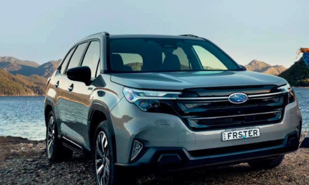 Front view of the 2026 Subaru Forester Hybrid parked by a lake with mountain scenery in the background.
