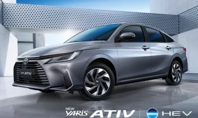 A silver Toyota Yaris Ativ HEV parked in a modern, minimalist setting with metallic walls and geometric patterns, showcasing its sleek design and alloy wheels.