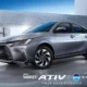A silver Toyota Yaris Ativ HEV parked in a modern, minimalist setting with metallic walls and geometric patterns, showcasing its sleek design and alloy wheels.
