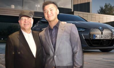 Ramon Ang and Jacob Ang smiling together in front of a BMW electric car.
