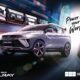 The new Geely Coolray driving through a futuristic city with motion blur lights, showcasing its sporty design and modern LED headlights.